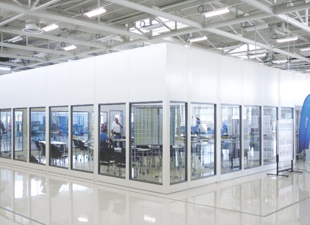 a Portafab enclosure inside a large office space